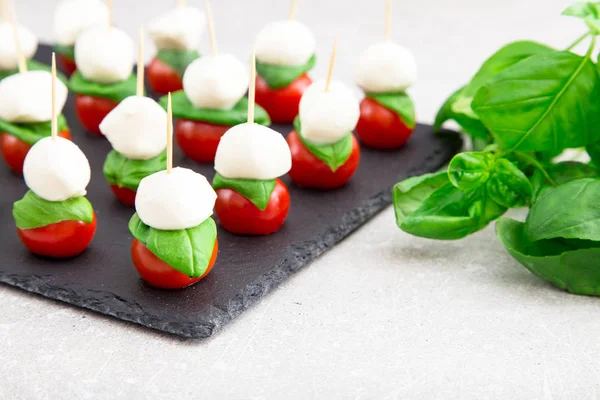 Caprese salad. Skewers with tomato and mozzarella with basil. — Stock Photo, Image