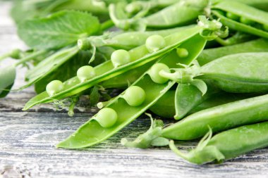 Ahşap zemin üzerine yeşil bezelye. hearthy taze ev yapımı bezelye.