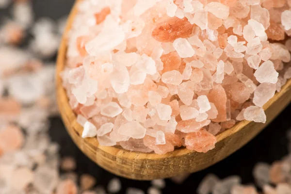 Himalayan pink crystal salt. spoon of pink himalayan salt on sla
