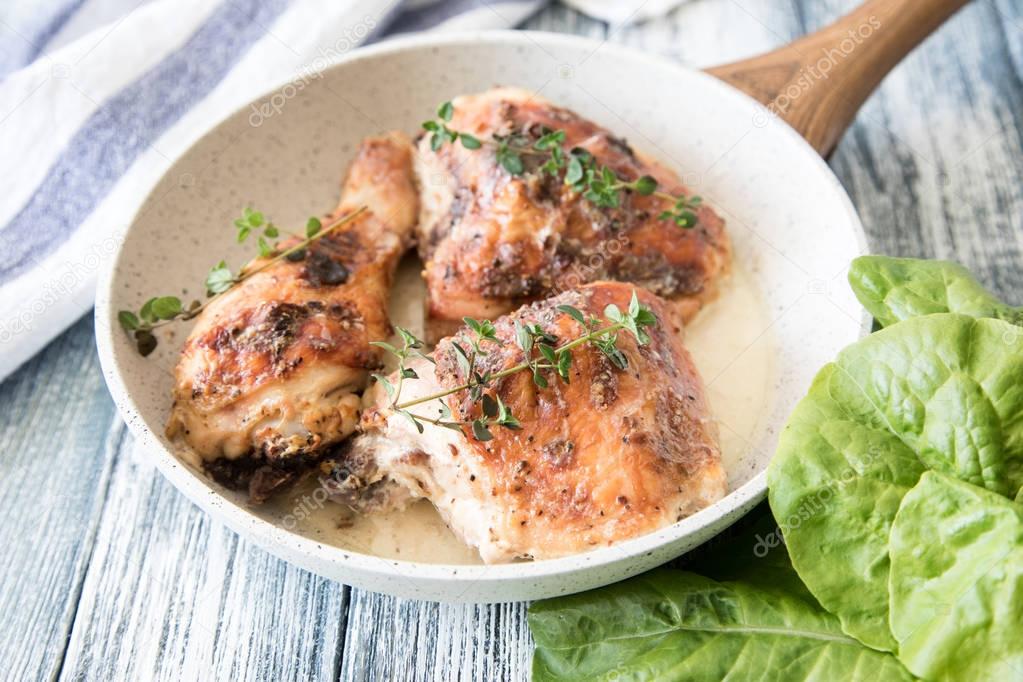 Fried golden chicken thighs with spices and herbs. Baked chicken