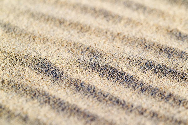 Lines in the sand of a beach. Sand texture.