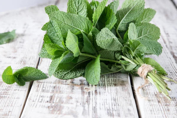 Mint. Bunch of Fresh green organic mint leaf on wooden table clo