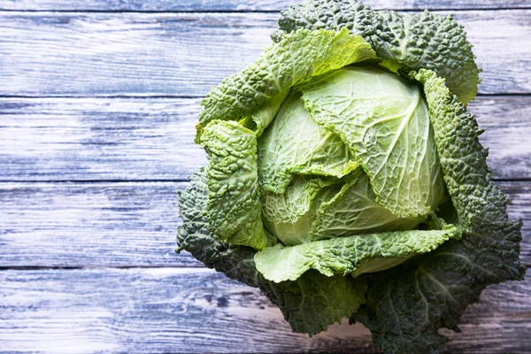 Ahşap arka plan üzerinde ham savoy lahana. Organik gıda