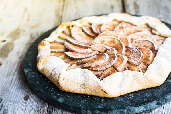 Pie with apples, pears and cinnamon on an old wooden background