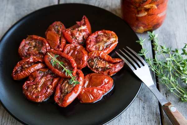 Güneş kase domates ahşap arka plan üzerinde kurumuş. Tomat kurutulmuş
