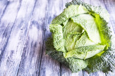 Ahşap arka plan üzerinde ham savoy lahana. Organik gıda