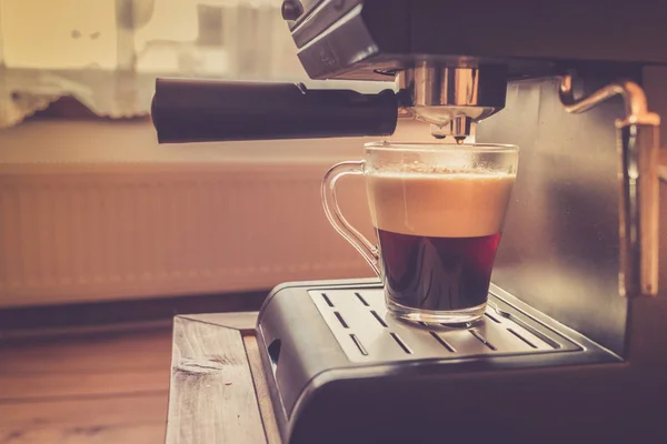 Espresso machine pouring strong looking fresh coffee in a  glass — Stock Photo, Image