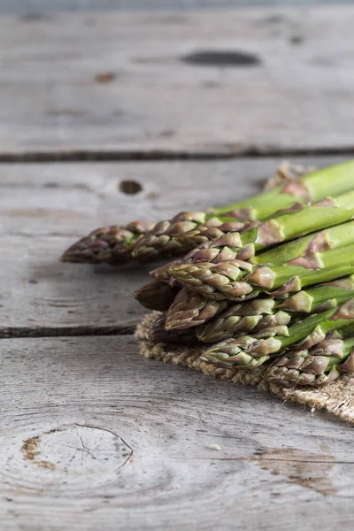 green Asparagus. Bunches of green asparagus on a grey wooden rustic background