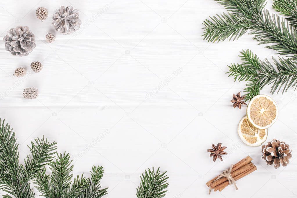 Christmas decoration of fir tree and conifer cone on wood background, top view. Space for text.