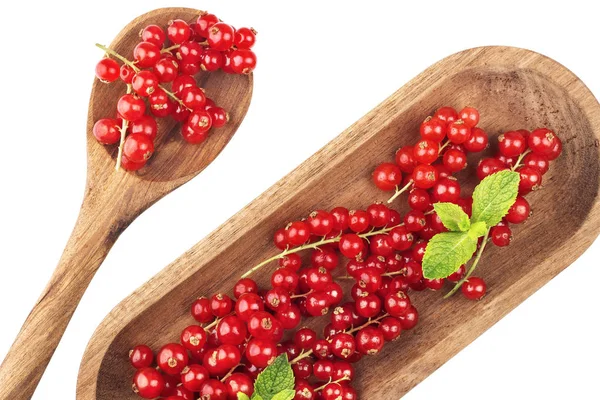 Ripe redcurrants on wooden plate with spoon on a white background. Top view — Stock Photo, Image