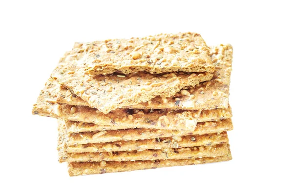 Stack of crispy wheat flatbread crackers with seeds isolated on a white background Stock Photo