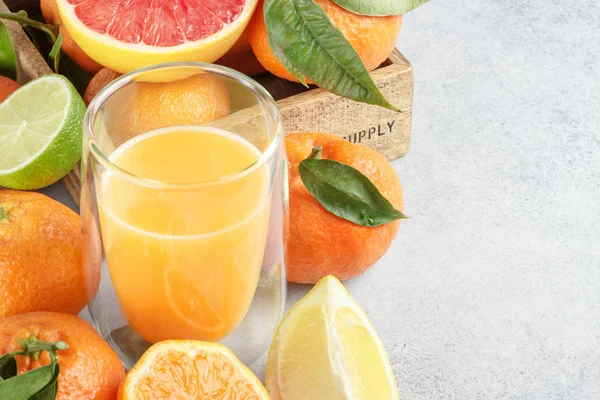 Citrice proaspete şi suc. Lămâie, limes, clementine, grapefruit pe fundal de piatră — Fotografie, imagine de stoc
