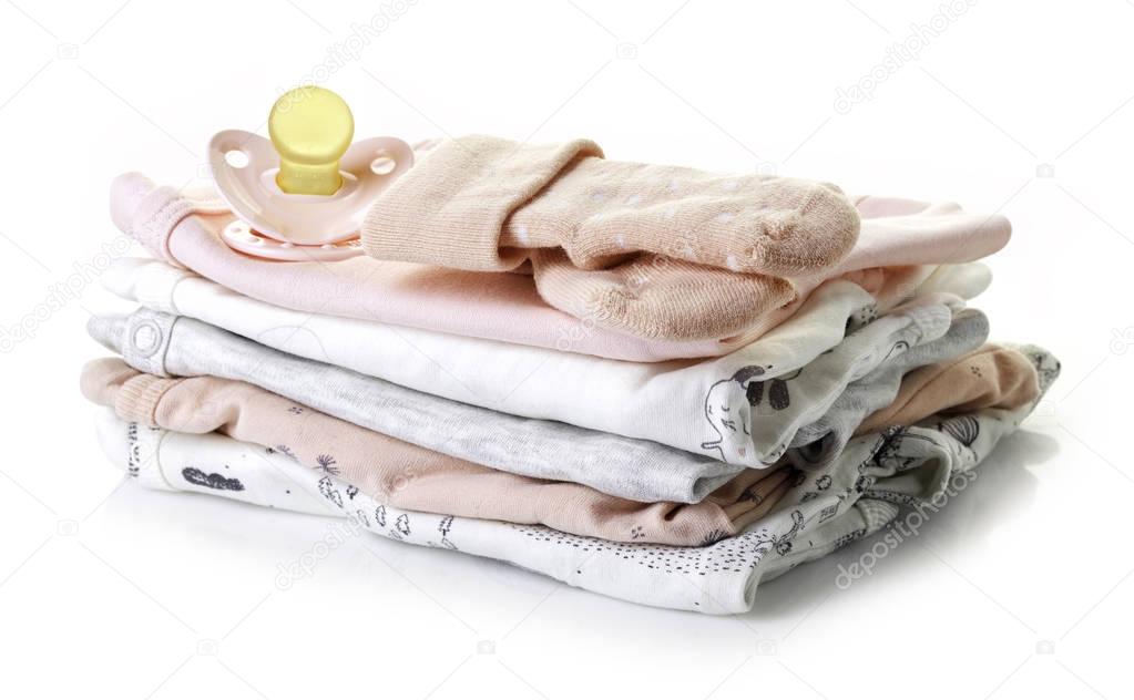 Pile of baby clothes isolated on white