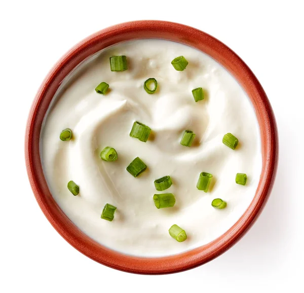 Bowl of sour cream with green onions isolated on white, from abo — Stock Photo, Image