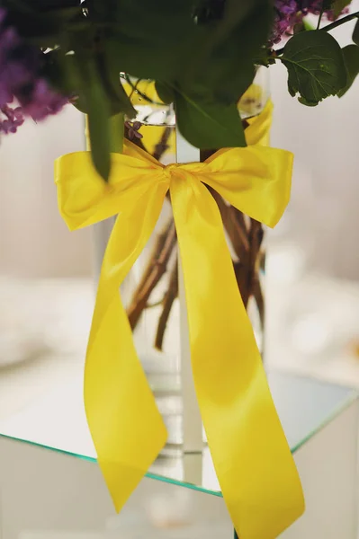 yellow bank on wedding vases on a table