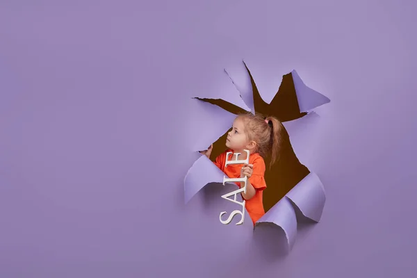 Cute Little Child Girl Breaks Colored Purple Paper Wall Toddler — 스톡 사진