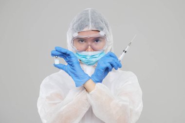 Biological hazard. Epidemic of the Chinese coronavirus. An asian woman in a protective suit and mask holds an injection syringe and vaccine. Vaccine from, flu, coronavirus, ebola, TB. 