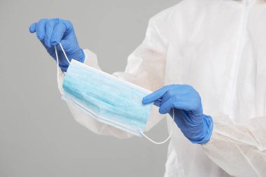 Doctors hands holding a protective mask against flu and viruses.