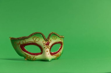 Festive, colorful masks of Mardi Gras or carnival mask on green background. Venetian masks.