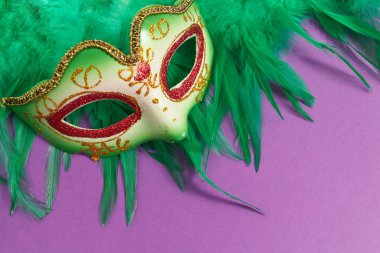 Mardi Gras 'nın renkli maskeleri ya da mor arka planda karnaval maskeleri. Venedik maskeleri ve tüyleri