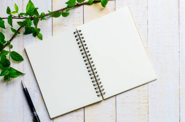 boş not defteri ve beyaz masa üzerinde siyah kalem