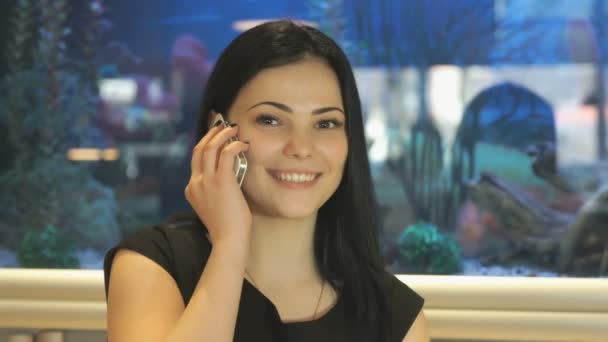 Bir cep telefonu üzerinde konuşurken çekici esmer — Stok video