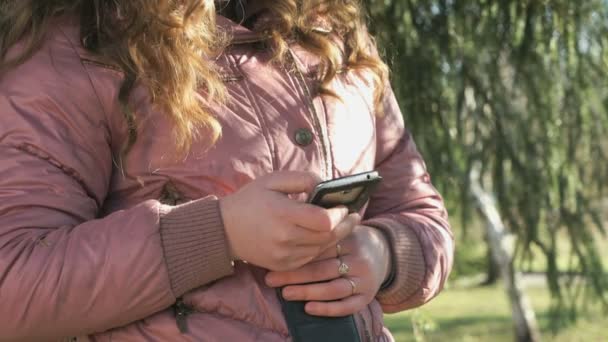 A vonzó lány egy mobil telefon tartó — Stock videók
