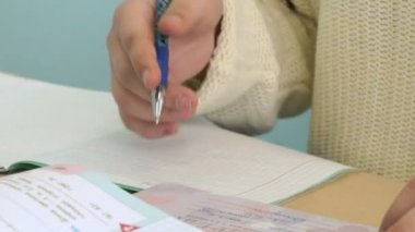 Kız sınıfta not defterinde yazıyor