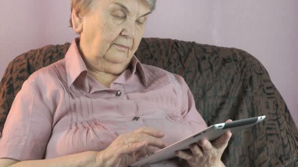 De oude vrouw houden de zilveren tabletcomputer — Stockvideo