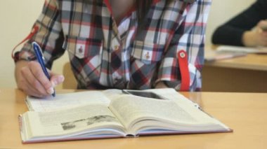 Kız metin içinde defterini ders yazar