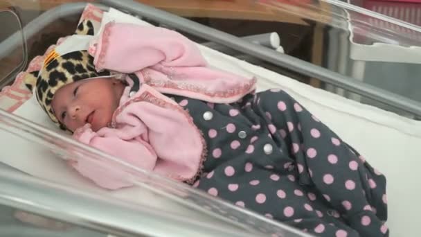 Newborn baby girl lying on medical couch. Close up — Stock Video