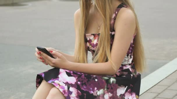 Молода дівчина з мобільним телефоном на відкритому повітрі — стокове відео