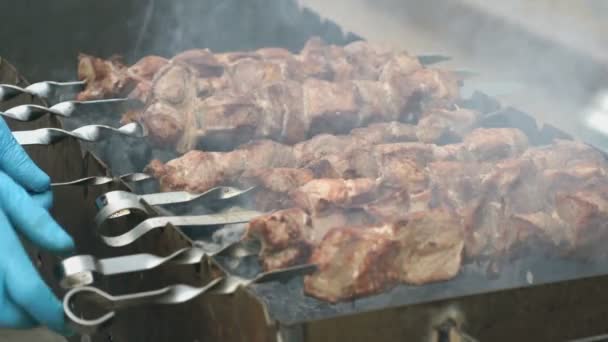 Frying of marinated meat on metal skewers on coals — Stock Video