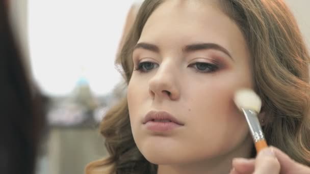 Maquiagem artista fazendo maquiagem para uma menina — Vídeo de Stock