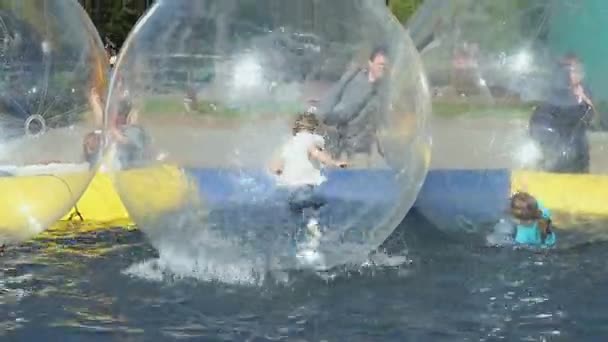 Little girl flounders inside large inflatable ball — Stock Video