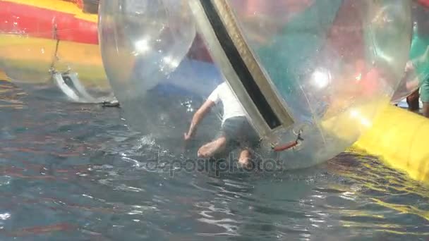 Little girl and boy inside a big inflatable balls — Stock Video