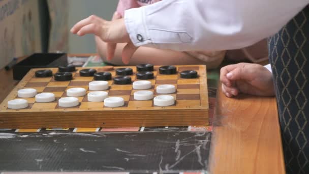 Children play checkers at a kindergarten. Close-up — Stock Video