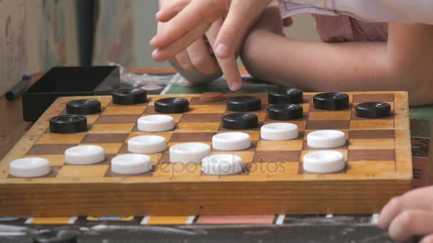 Little boys playing checkers at the garden — Stock Video