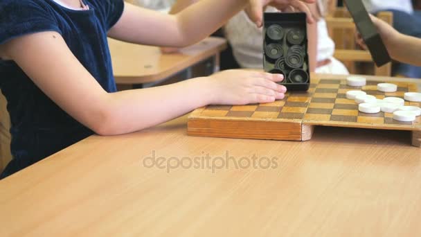 Little girls playing checkers at the garden — Stock Video