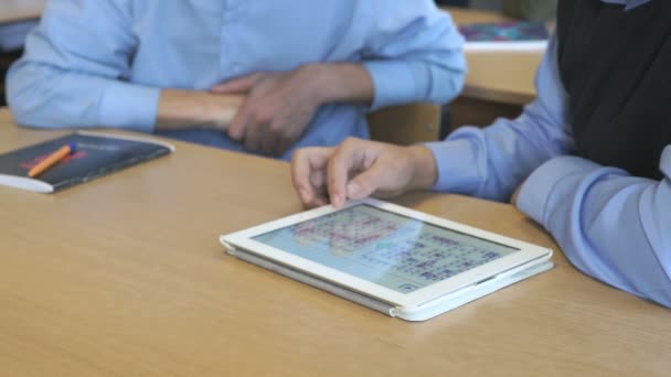 Schoolboy aged 14s plays the game using a tablet — Stock Video