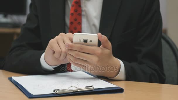 Man sitting writing the text using the smartphone — Stock Video