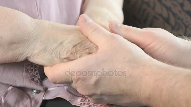 Мужчина успокаивает пожилую женщину во время стресса — стоковое видео