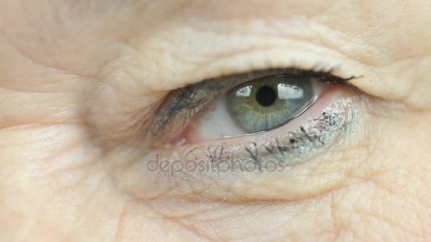 Adult woman blinking one eye. Close up — Stock Video