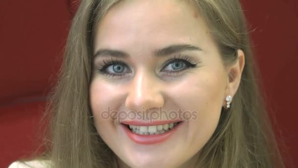 Positive junge Frau lächelt in die Kamera — Stockvideo