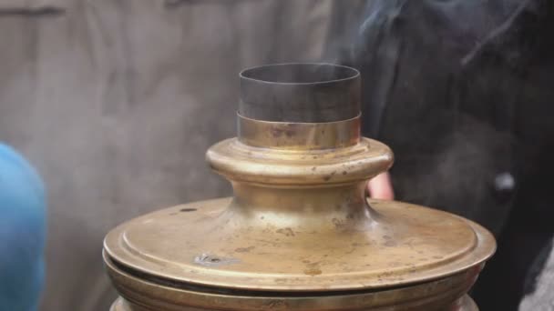 People standing around russian boiling samovar — Stock Video