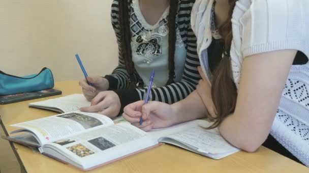 2 つの生徒はレッスンで教科書のページを反転します。 — ストック動画