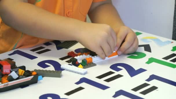 Preschool jongen verzamelen de ontwerper in een kinderdagverblijf — Stockvideo