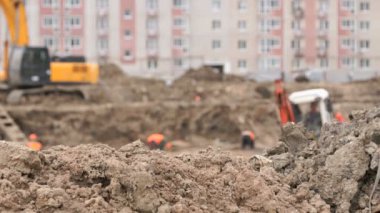 İnşaat için büyük kil çukura inşaatçılar çalışmak