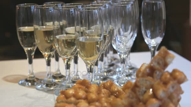 Close-up of glasses of sparkling wine on table — Stock Video