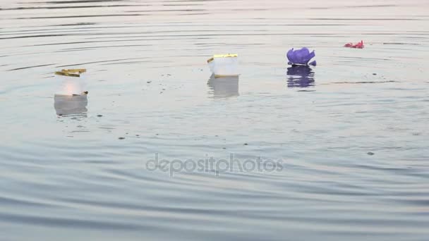 Different colors water lilies with candle on water — Stock Video